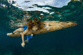   This JenJen happy kid Apo Island paddling around his sophisticated bamboo boat. boat  